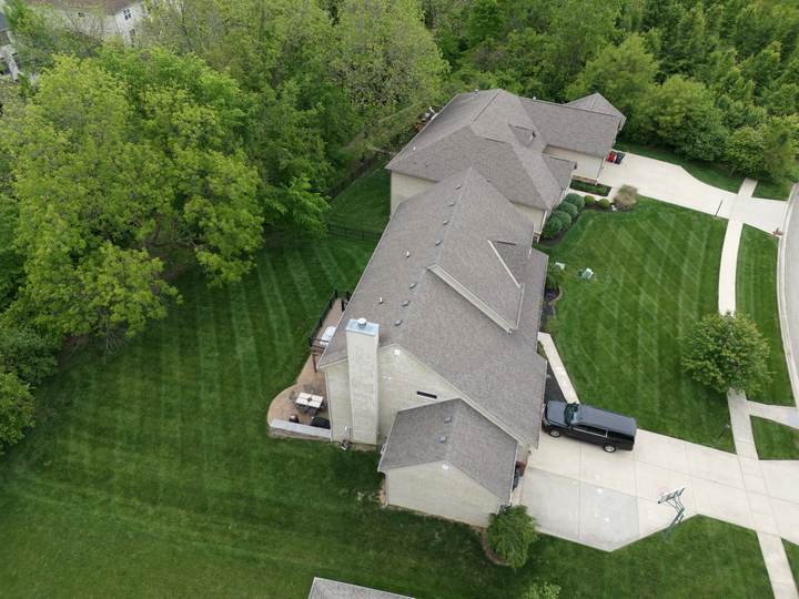 Aerial view of a freshly striped lawn around a house