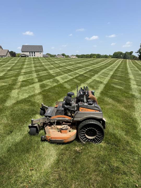 Checkerboard mowing pattern on a large lawn with a stand-on mower