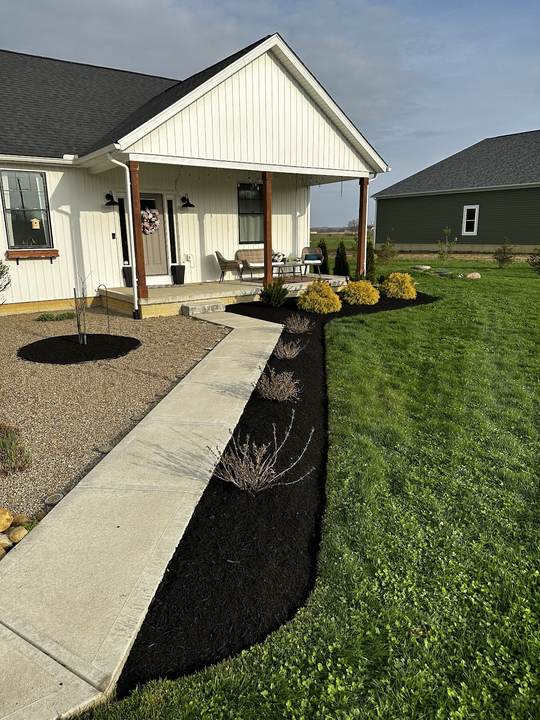 Fresh black mulch bed along a front walkway